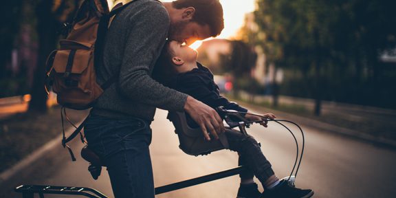father and son on a bike