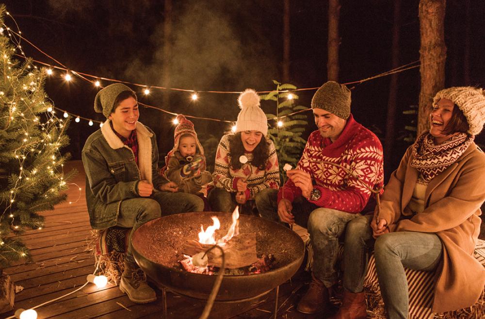 family roasting marshmallows around a fire